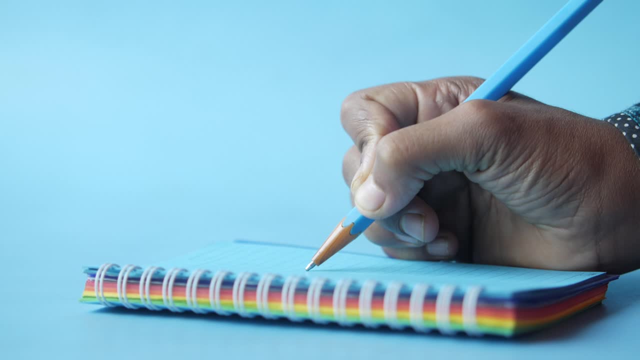 Hand Writing Notes in Spiral Notebook