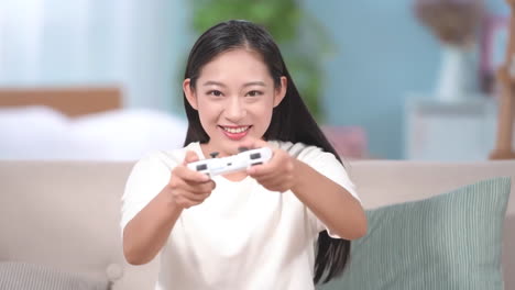 beautiful young woman is intensely playing console video game in a modern and lively home interior