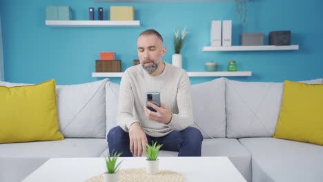 Man-looking-at-phone-angry-and-stressed.