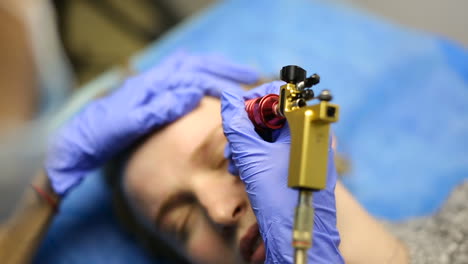 cosmetician working eyebrow make up at beauty-farm