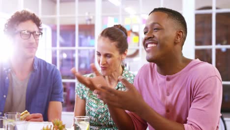 Casual-colleagues-talking-together-at-lunch