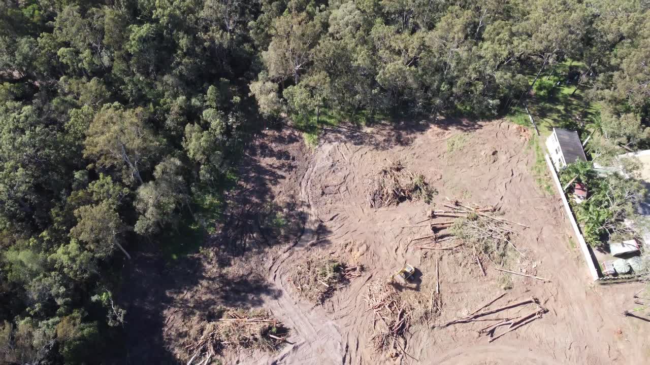 4K Aerial view of land being cleared by heavy machinery for a new subdivision in Australia