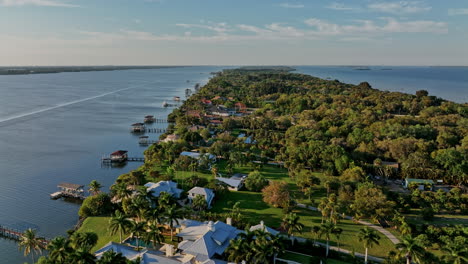 merritt island florida aerial v12 flyover residential neighborhood with upscale mansion homes, private docks, lush landscape bounded by indian and banana rivers - shot with mavic 3 cine - march 2022