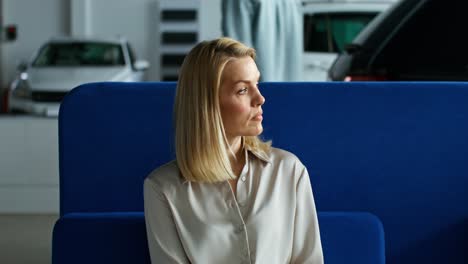 woman waiting at a car dealership