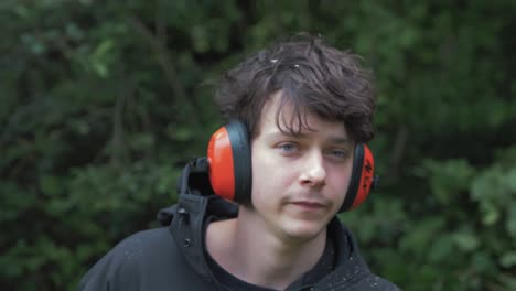 young man putting on headphones visor safety equipment