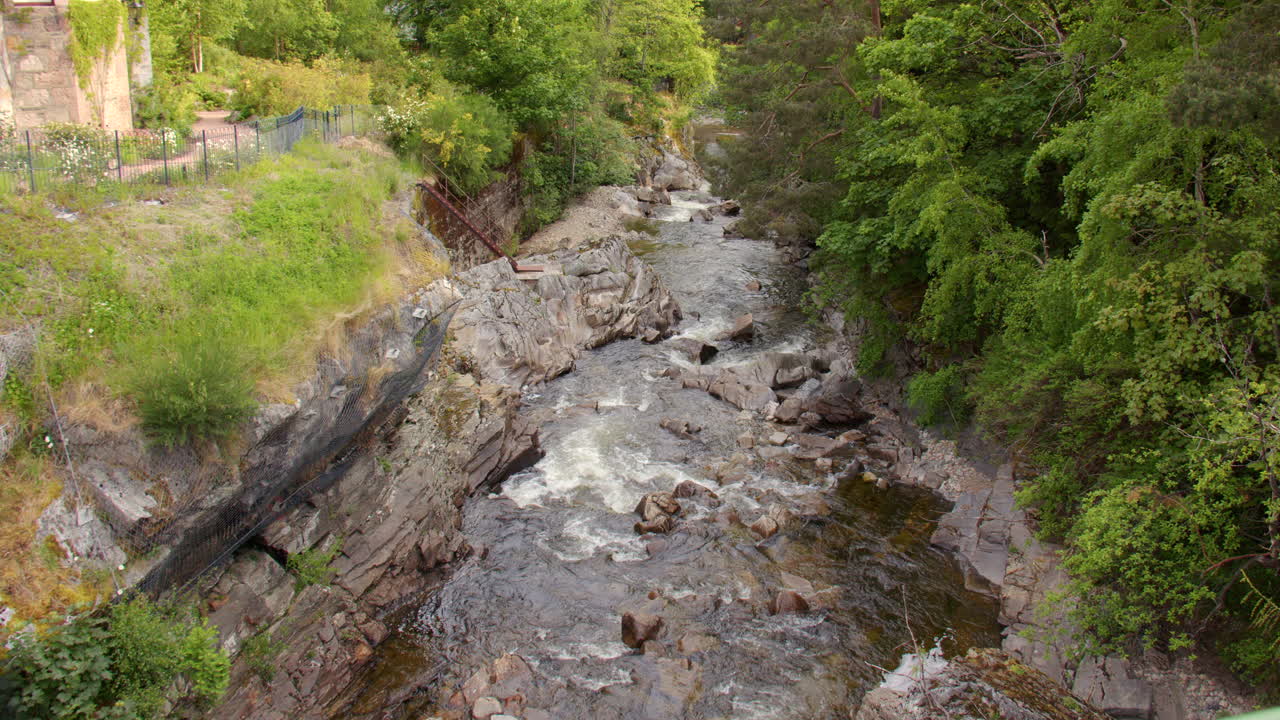 Wide shot of Clunie Water down stream, water falls at Mar road, braemar