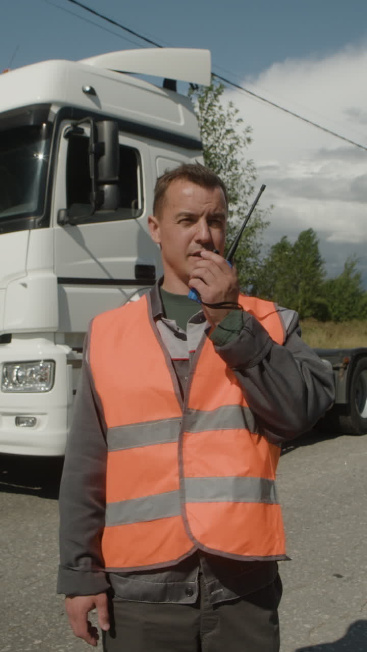 Man with Walkie Talkie in Front of Truck
