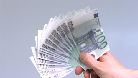 hand waving hundred euro notes