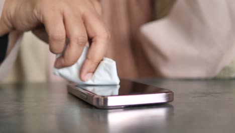 cleaning a smartphone screen with a tissue