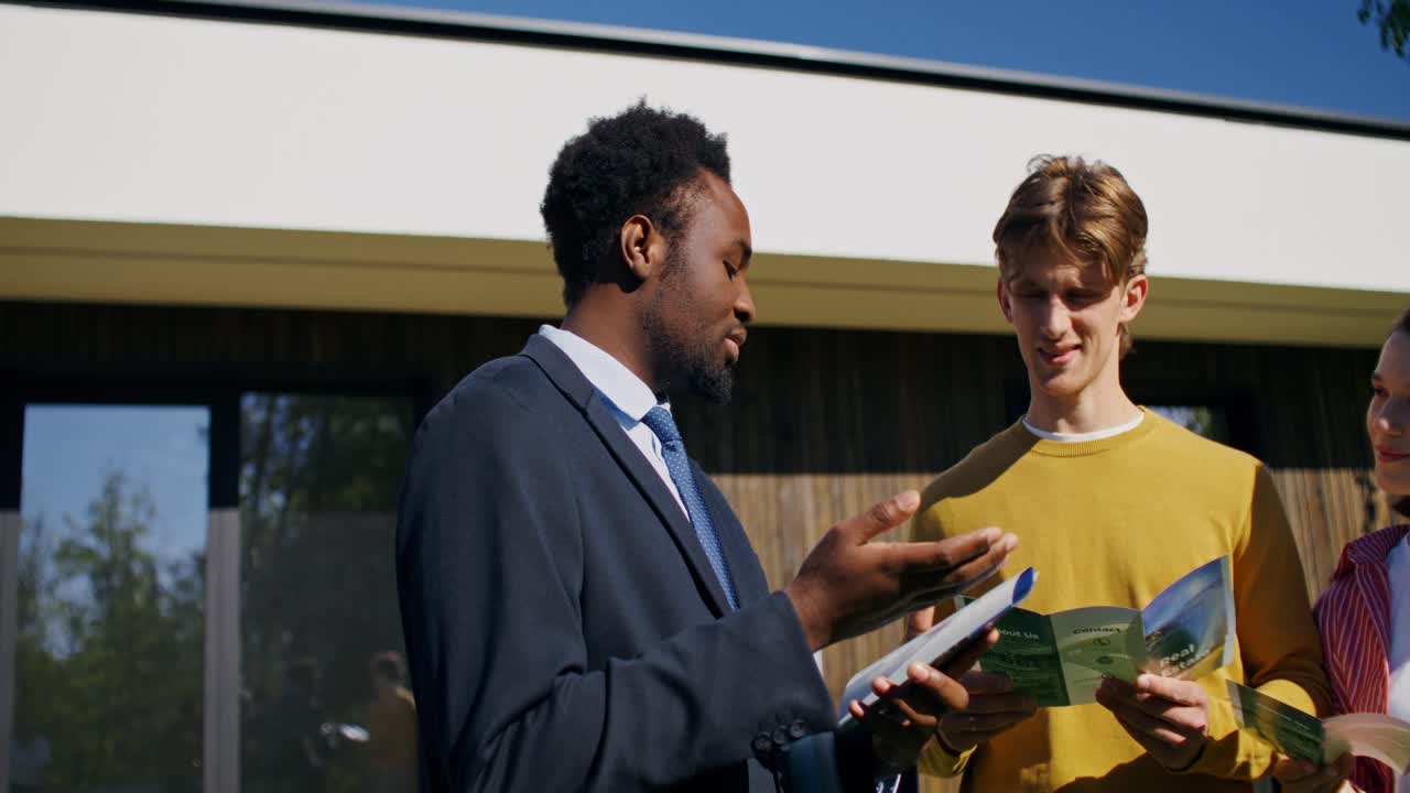 Real Estate Agent Discussing Property with Clients