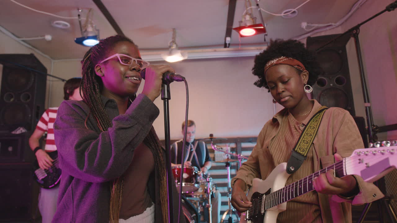 Multiethnic Music Band Rehearsing In Recording Studio 6