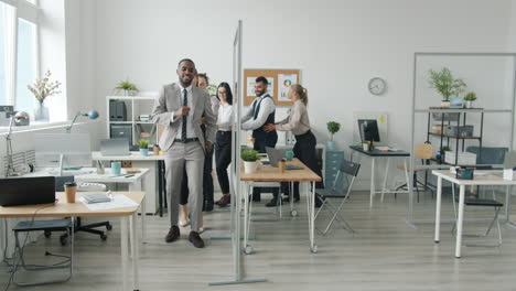 happy office team dancing