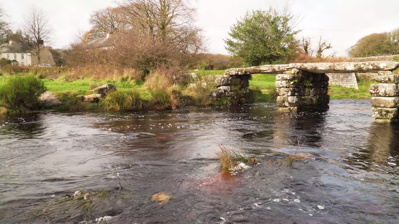 View of bridges of rough stone in the middle of the national park in the English country side with a stream under it