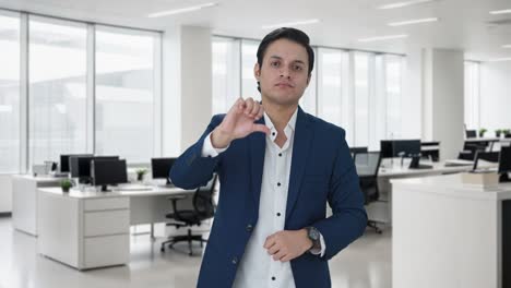 upset indian businessman showing thumbs down