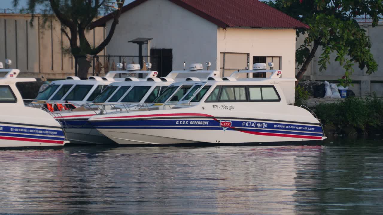 Ferry moored at pier marina port in Cambodia Southeast Asia over calm water