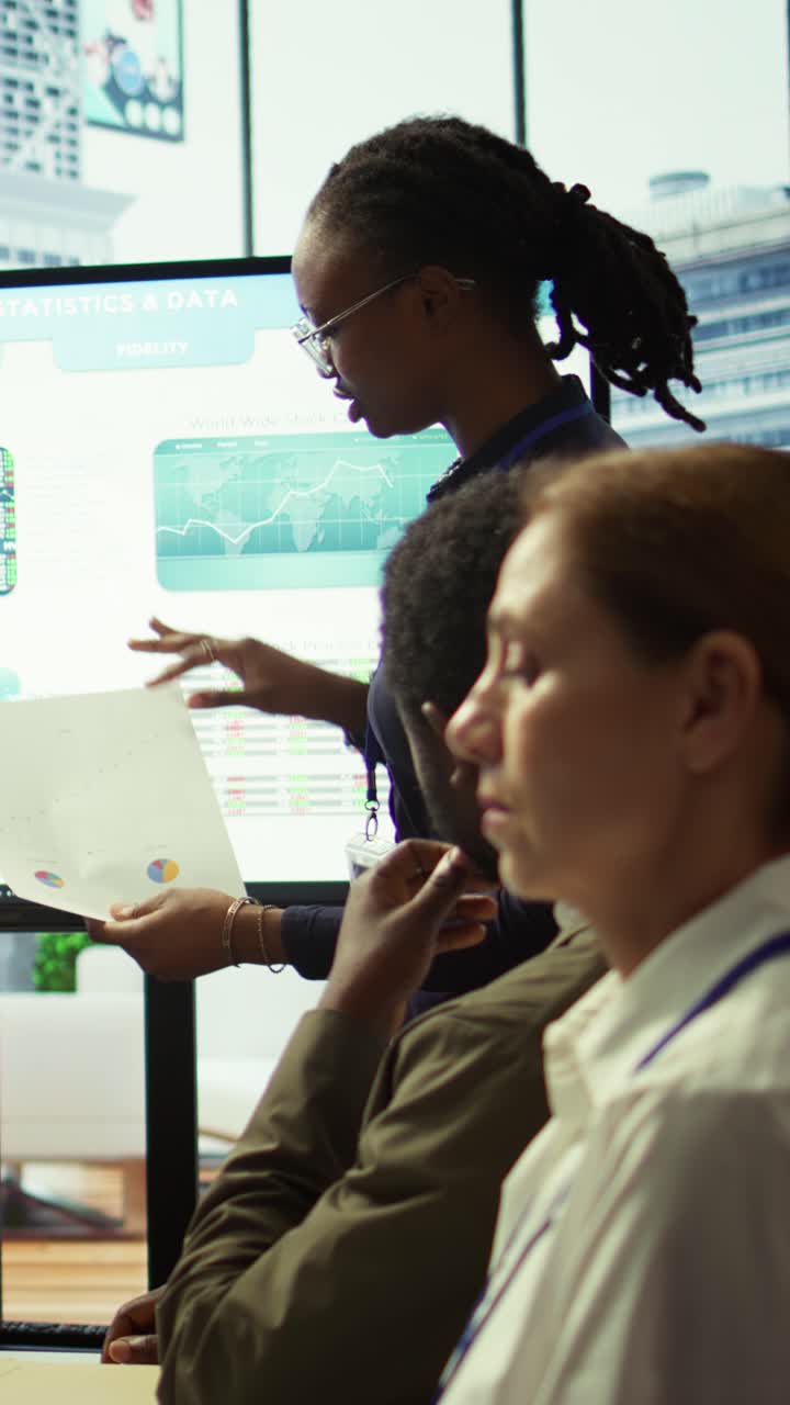 Vertical Video Employees team analyzing infographics to offer solutions for the new project