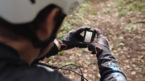 over shoulder shot of athlete review footage on small action camera screen