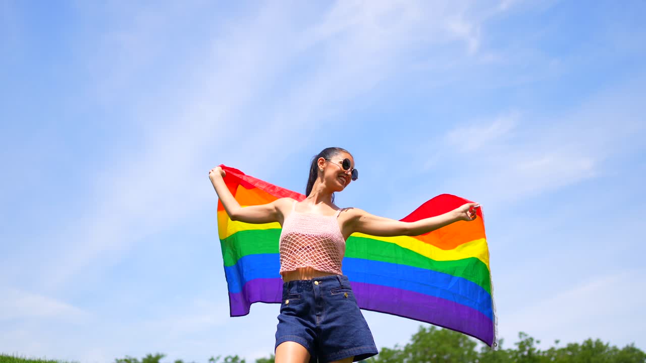 Woman celebrating Pride with a rainbow flag