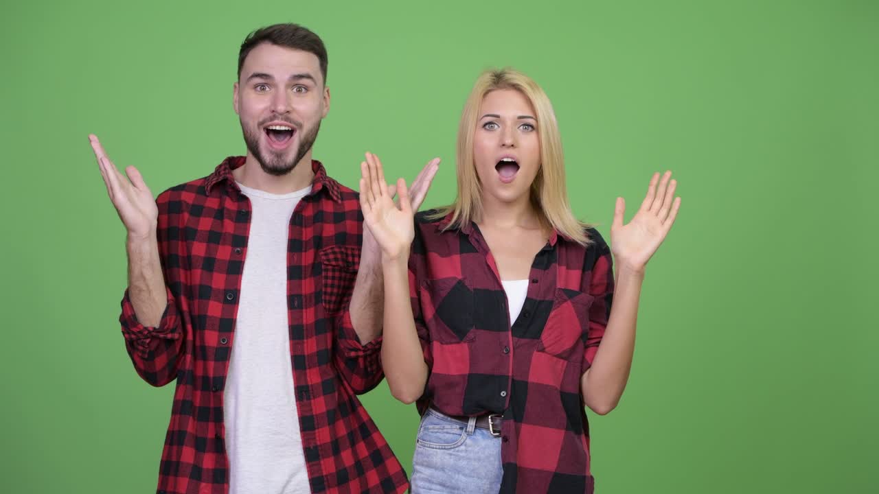 Young couple looking surprised together