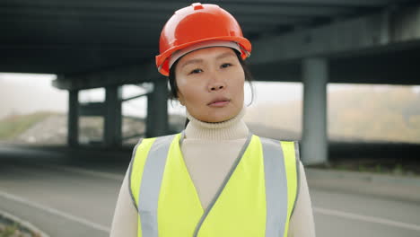 female construction worker under an overpass