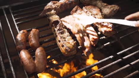 anonymous person preparing raw meat pieces above burning fire