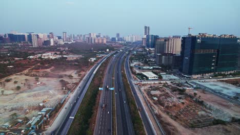 concrete mining with oor and glass facade building at nanakramguda, financial district, hyderabad, india. day time, pan shot, drone shot, 4k.