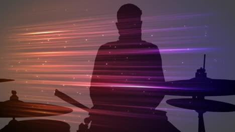 animación de rastros de luz coloridos que se mueven sobre la silueta del baterista masculino