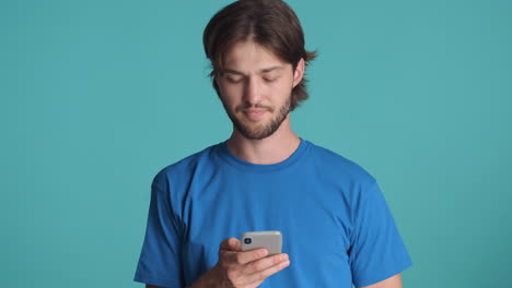 Caucasian-man-in-front-of-camera-on-blue-background.