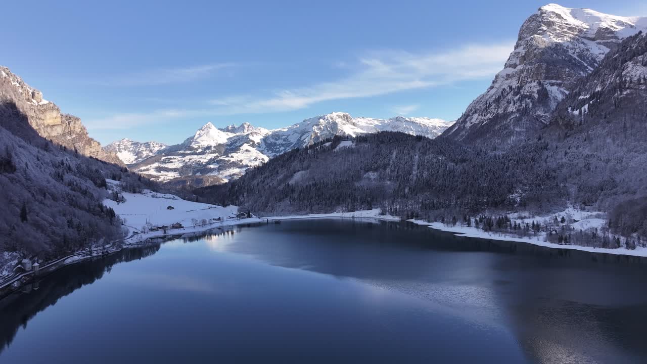 Snow covered Klöntalersee and surrounding peaks in Glarus, Switzerland