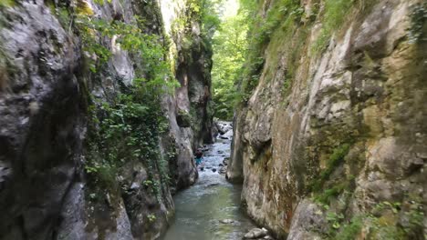 man walking canyon river aerial view