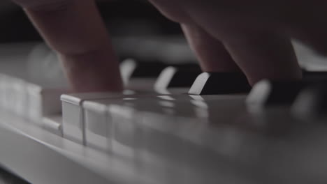 playing piano keys on midi keyboard in home recording studio