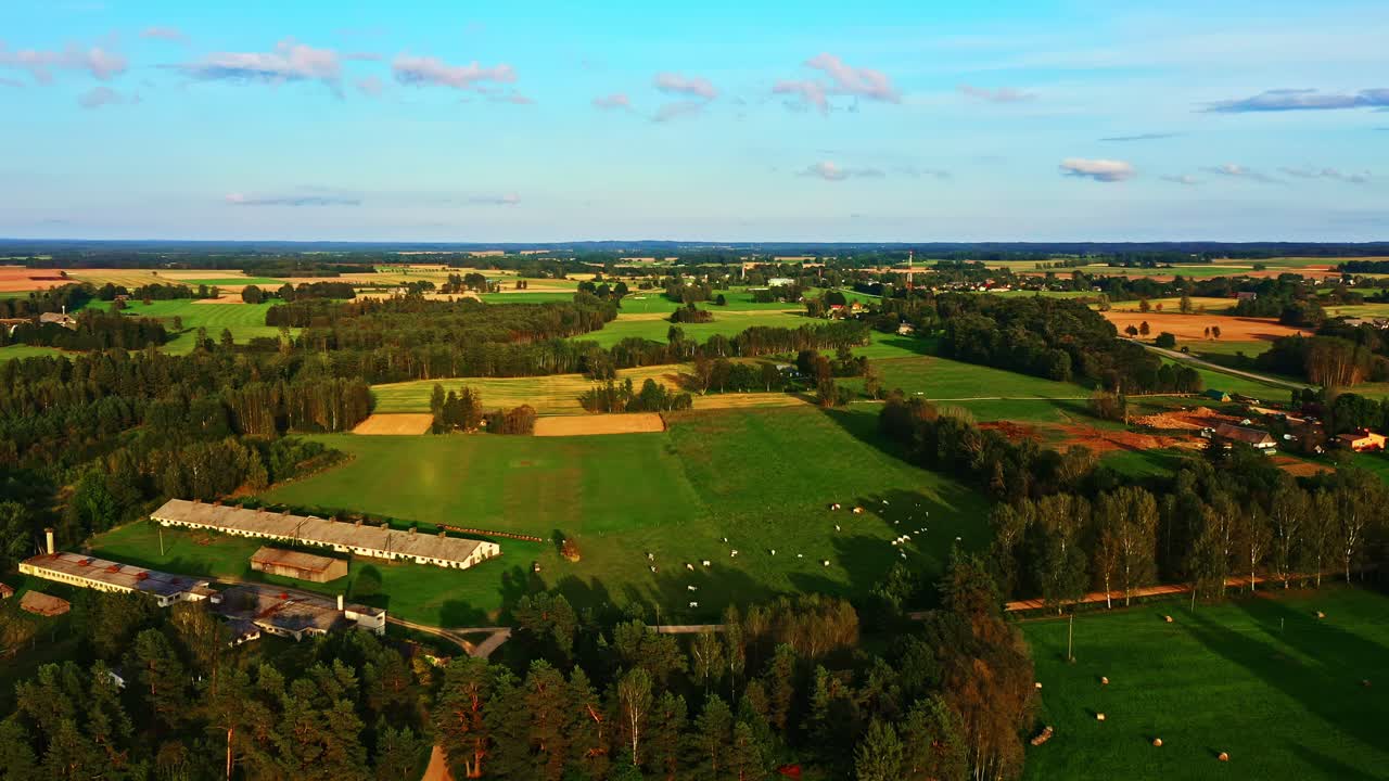 Flying Over Colorful Patchwork Farmland With Fields, Trees, and Distant Villages