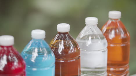 different colors of coconut wine or lambanog stored in plastic bottles