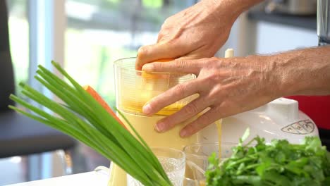 Juice-oranges-to-make-sauce-for-zoodles-adding-to-bowl-healthy-vegan-vegetarian-lifestyle-diet-detox