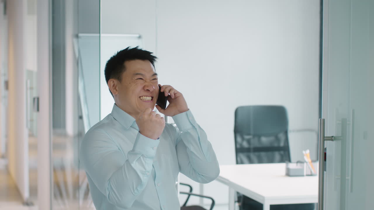 Businessman Celebrating Good News on Phone Call
