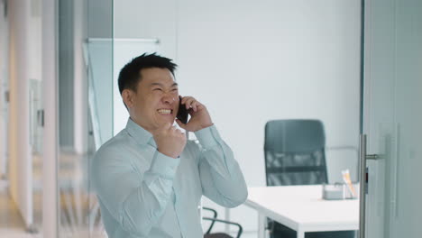 businessman celebrating good news on phone call