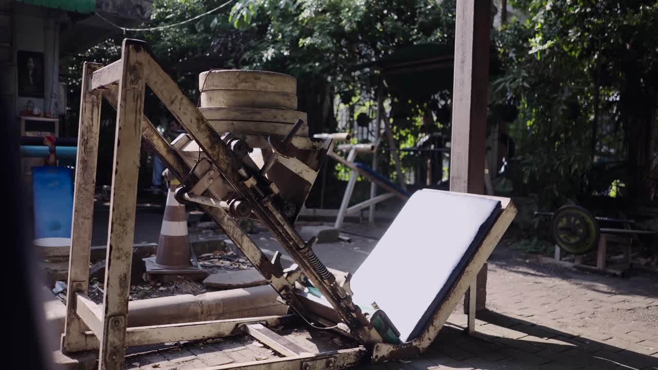 Outdoor Leg Press Machine in a Rustic Gym Setting