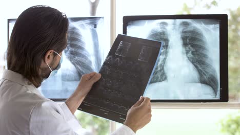 senior doctor analyzing x-ray scan of dangerous respiratory medical condition in thorax