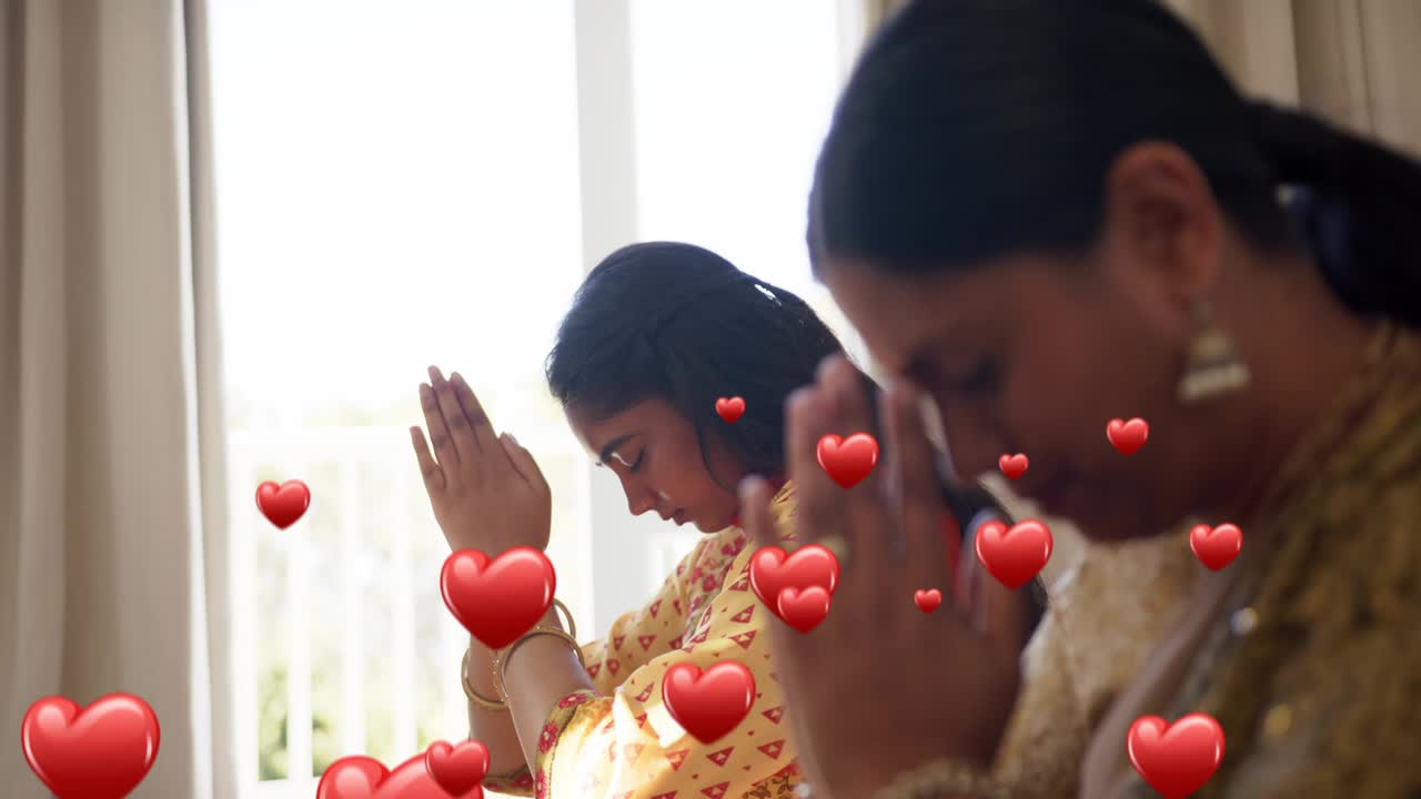 Two women praying by door for health, heart popping, causing hearts rising over them