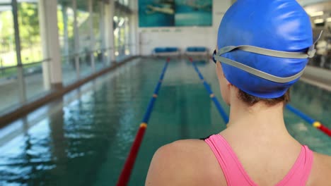 female swimmer ready to dive into swimming pool