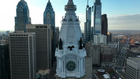 rising aerial reveals statue atop city hall