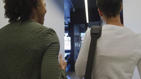 happy diverse business people discussing work and walking at office