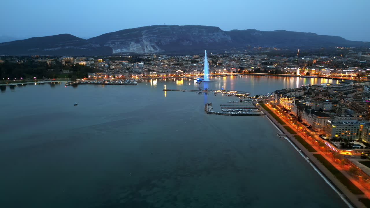 Aerial, drone view of the Geneva Water Fountain in Switzerland in the evening