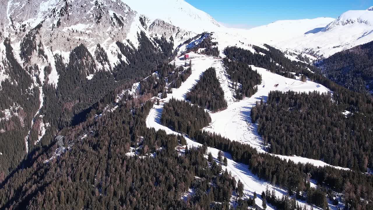 Snowy mountains and ski trails in the Alps of Italy during winter