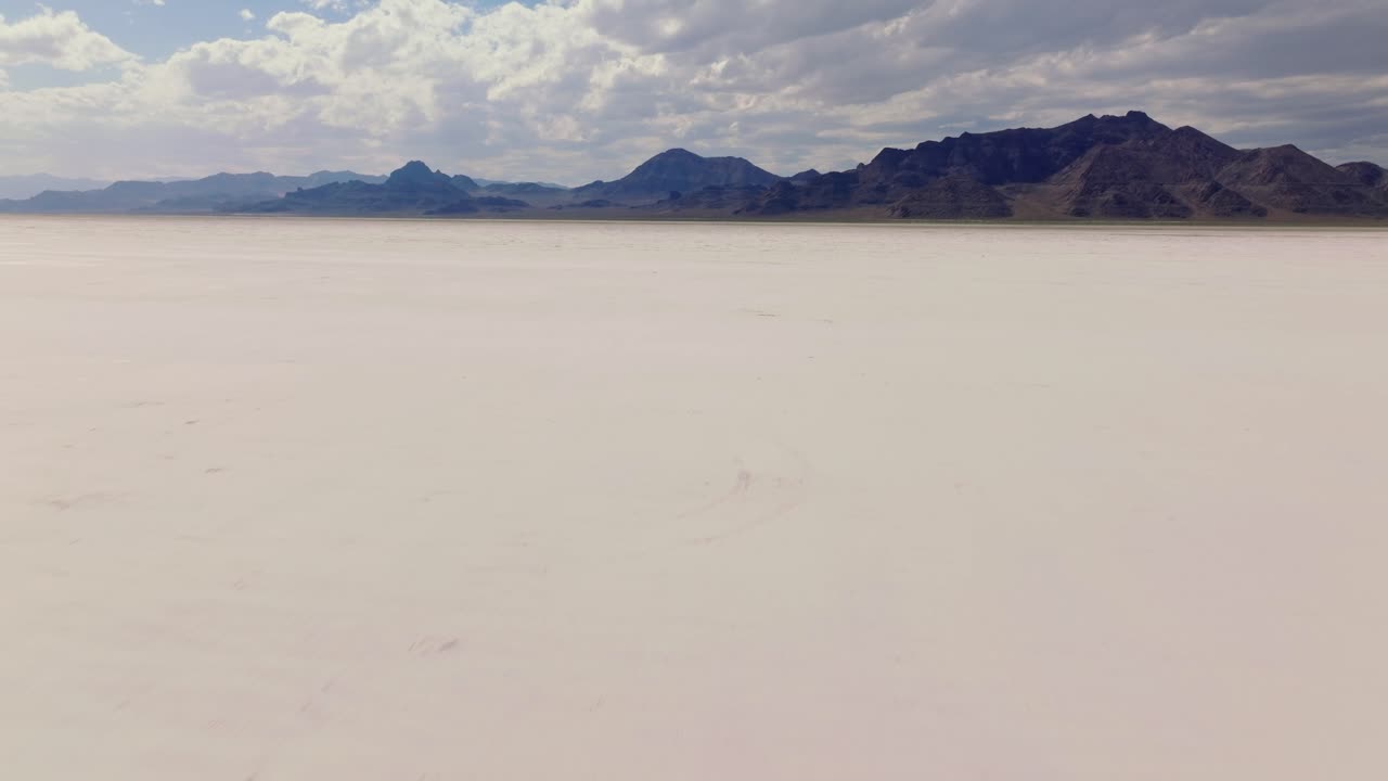 Vast Bonneville Salt Flats under cloudy sky, landscape of solitude and openness