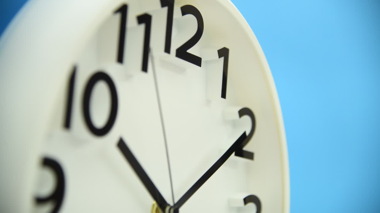 White wall clock on blue background
