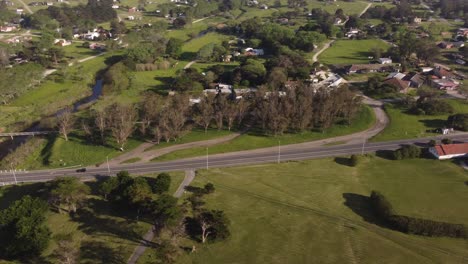 Car-driving-along-rural-road-in-Chapadmalal-village-in-Argentine