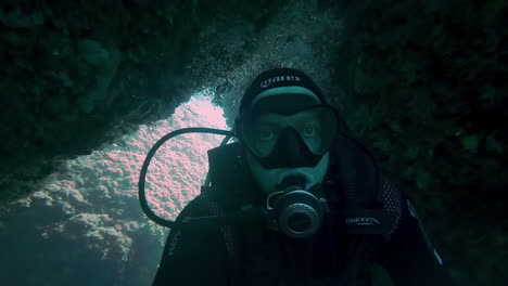 underwater clip of a scuba diving exploring the vibrant biodiversity in the coral rocks