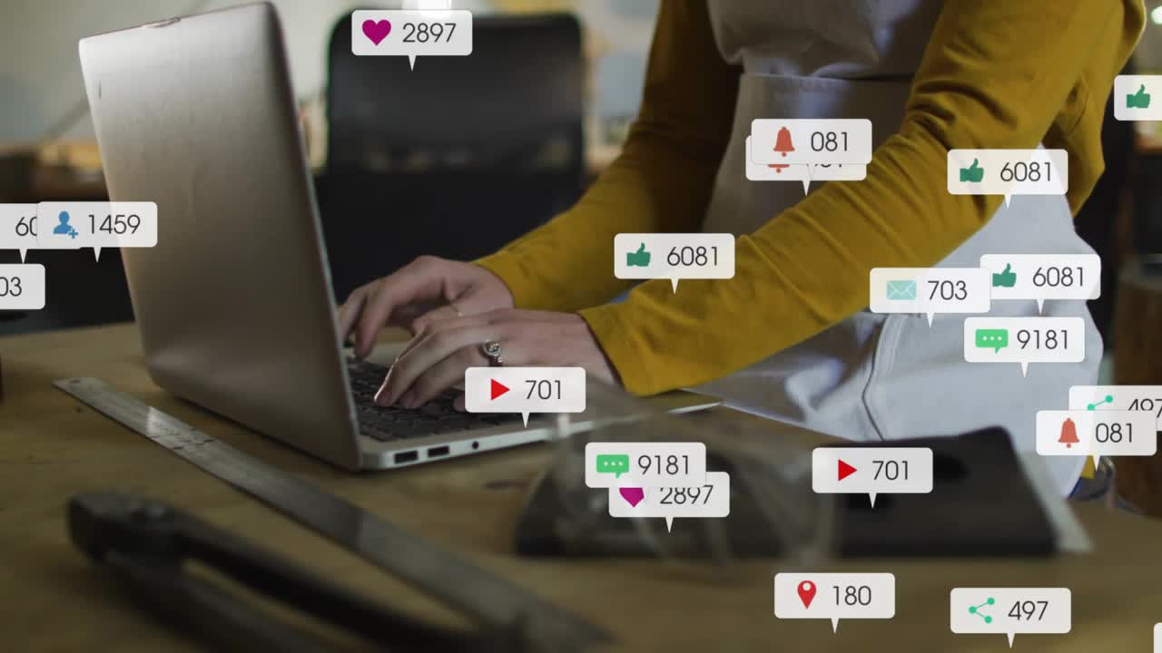 Mid-adult woman typing on laptop, notification icons rising then fading showing social media surge