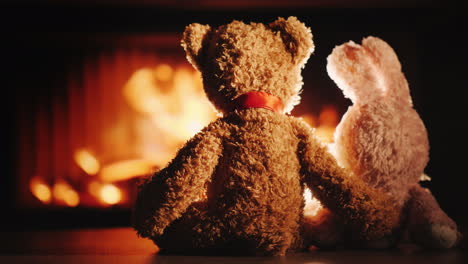 Bear-And-Rabbit-In-A-Hug-Sit-By-The-Fireplace-Valentine's-Day-Concept